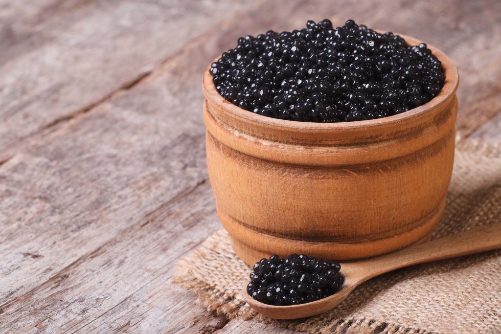 Wooden bowl and spoon with caviar