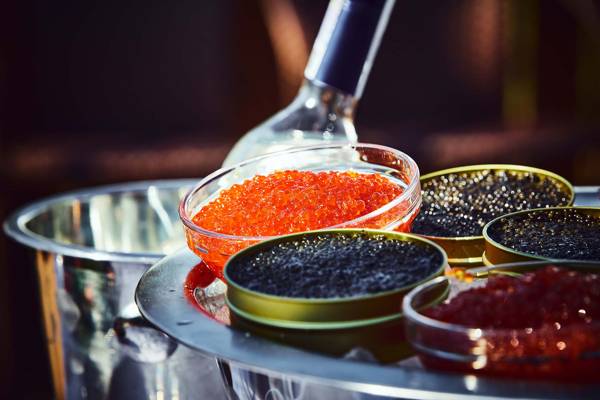 Covered and served furshet table, outdoor. Red and black caviar and vodka